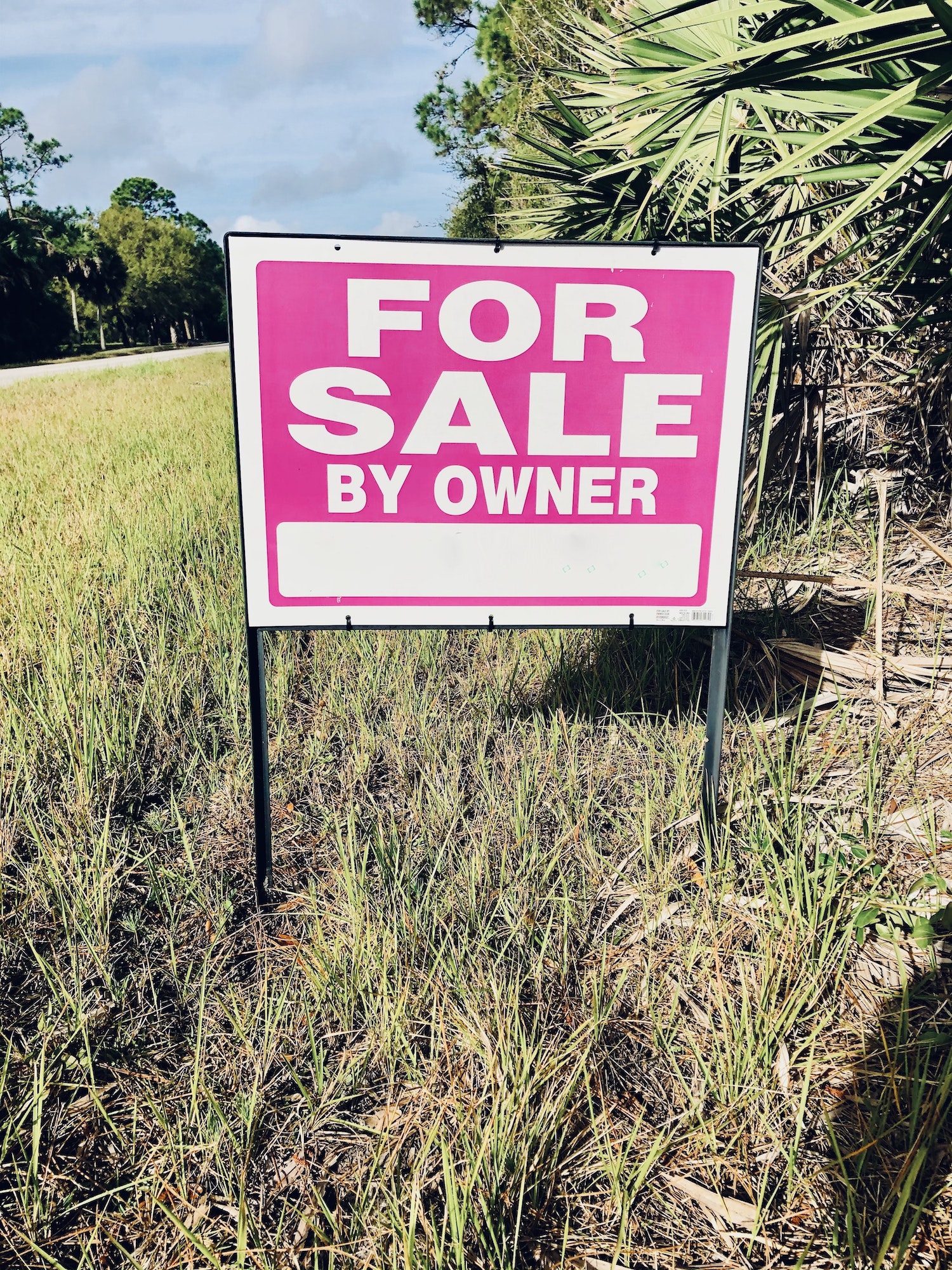 For sale by owner sign placed on a piece of property in hopes of selling their property.